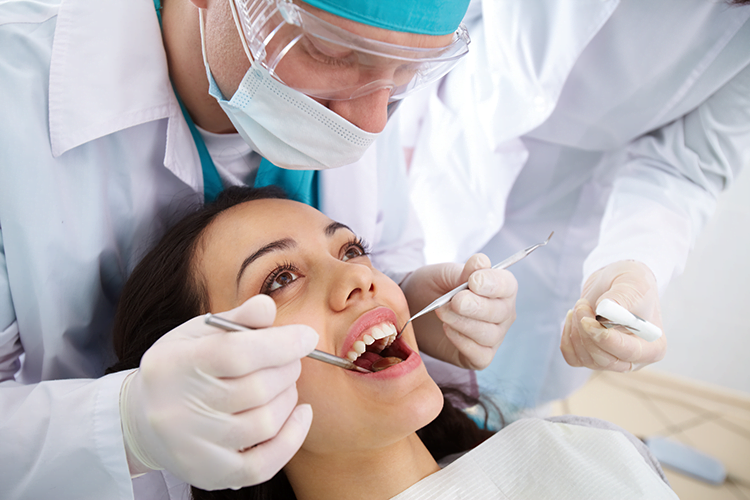 Dentist in Burwood solving dental problem of Client